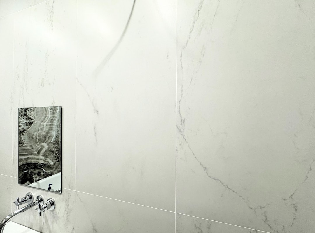 Marble bathroom wall with a small mirror.,