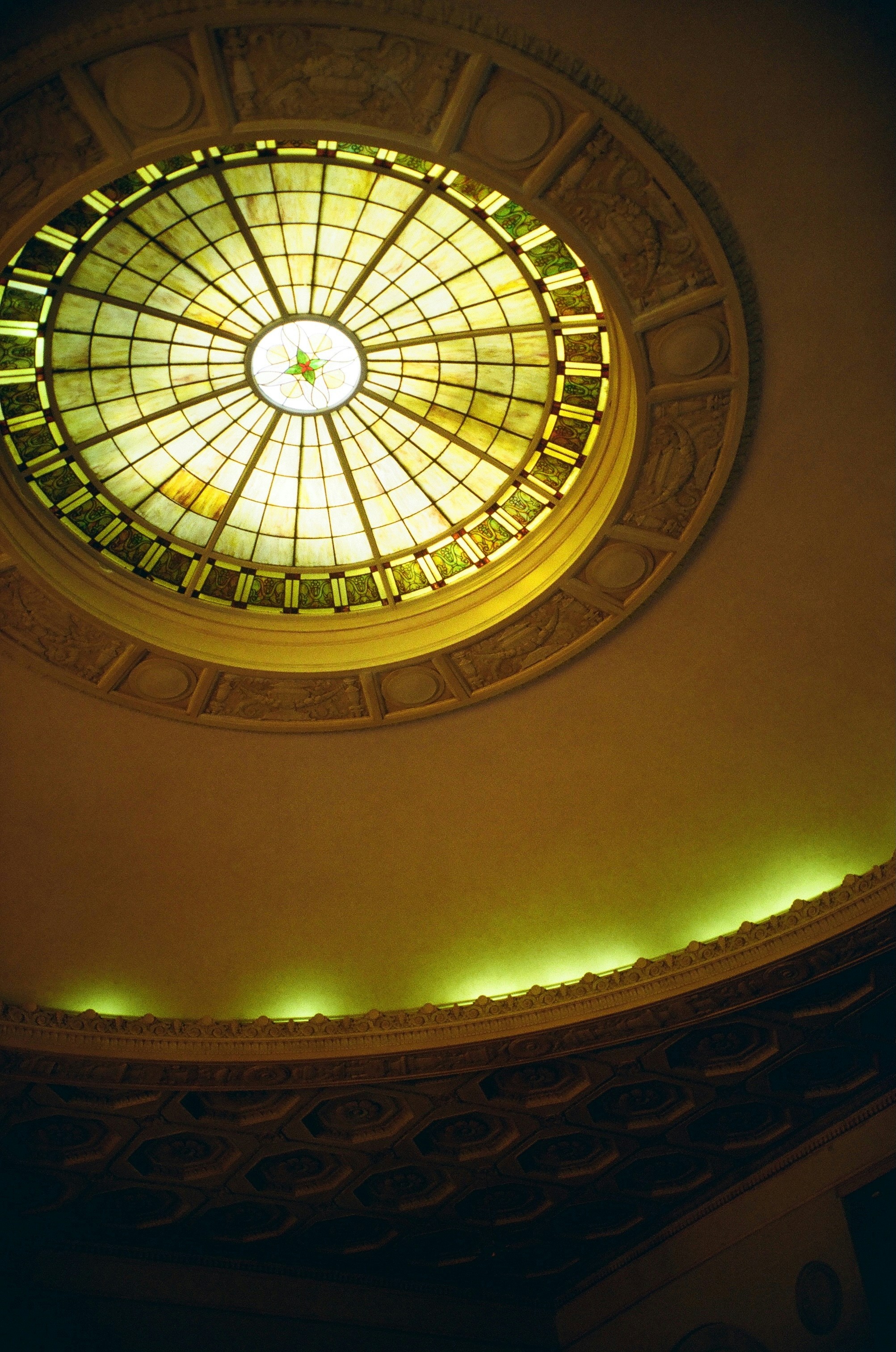A stained-glass skylight adorns a domed ceiling.