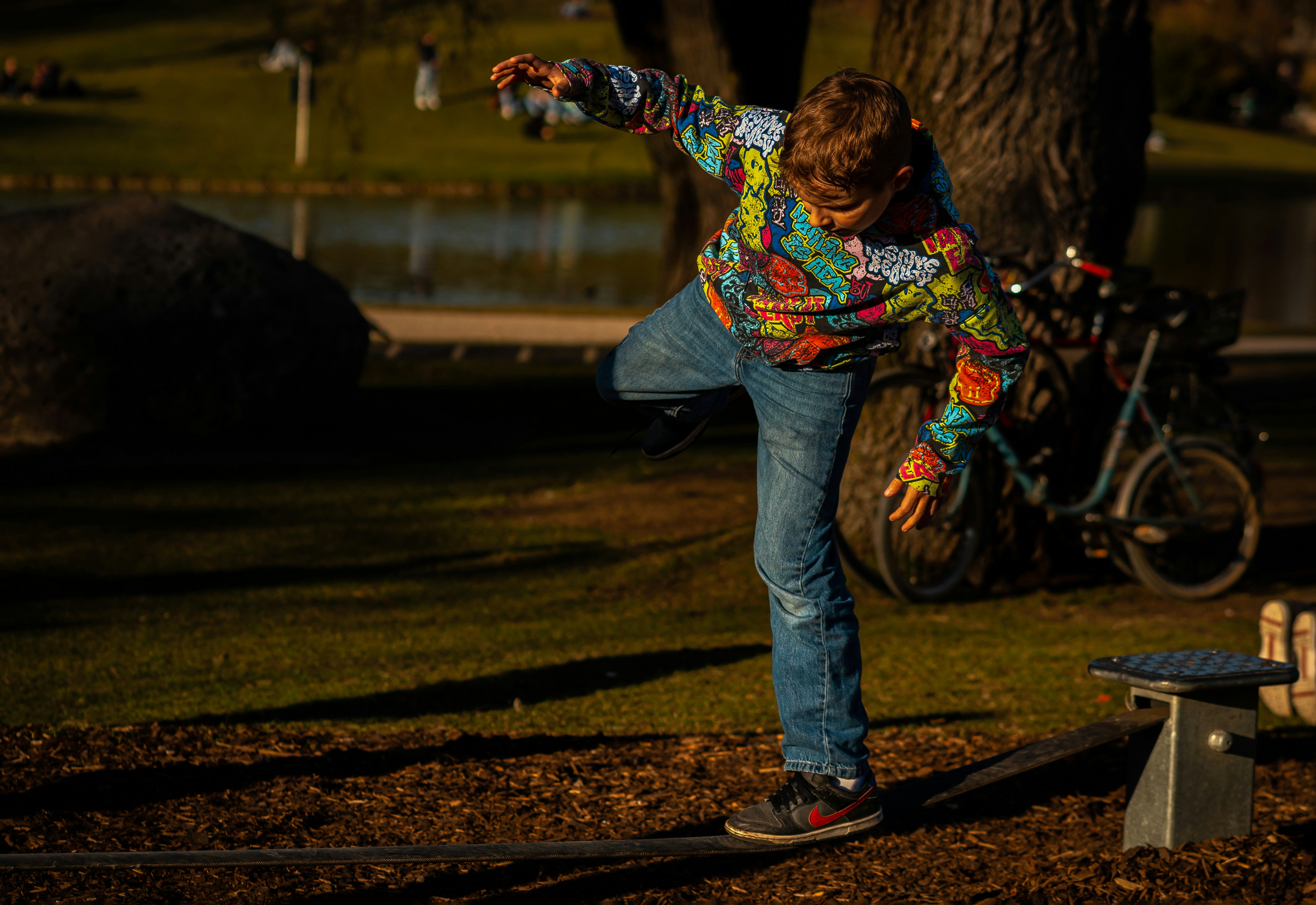 flow artist spinning a hoop in a park at golden hour