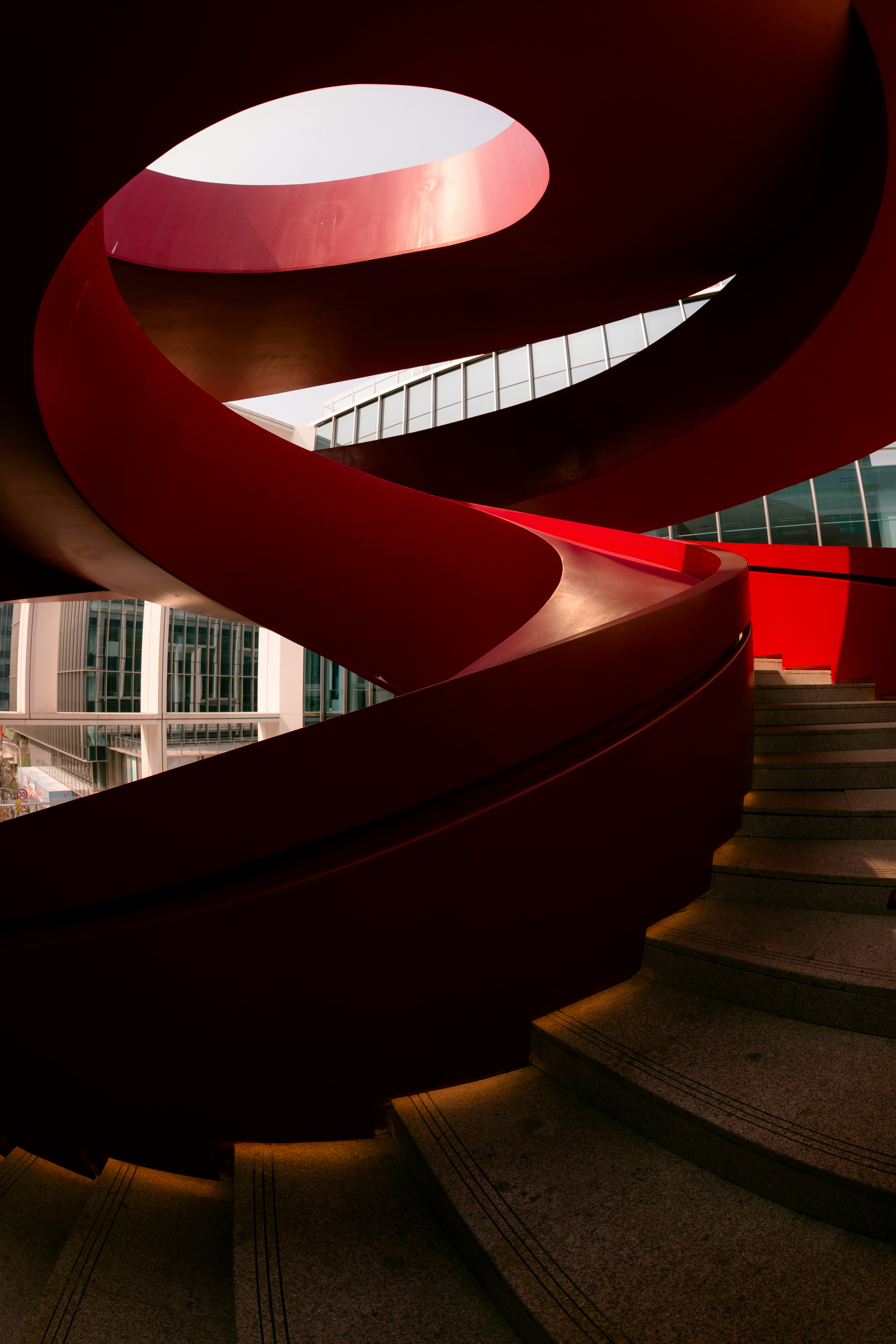 A red, swirling staircase reaches upward