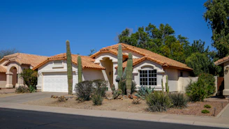 A house in the desert with cacti.