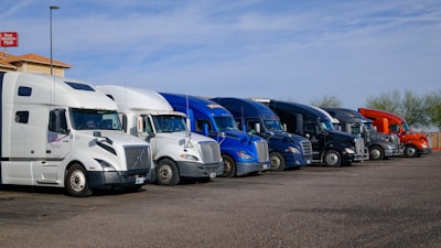 Several semi-trucks parked in a row.