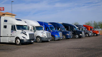 Several semi-trucks parked in a row.