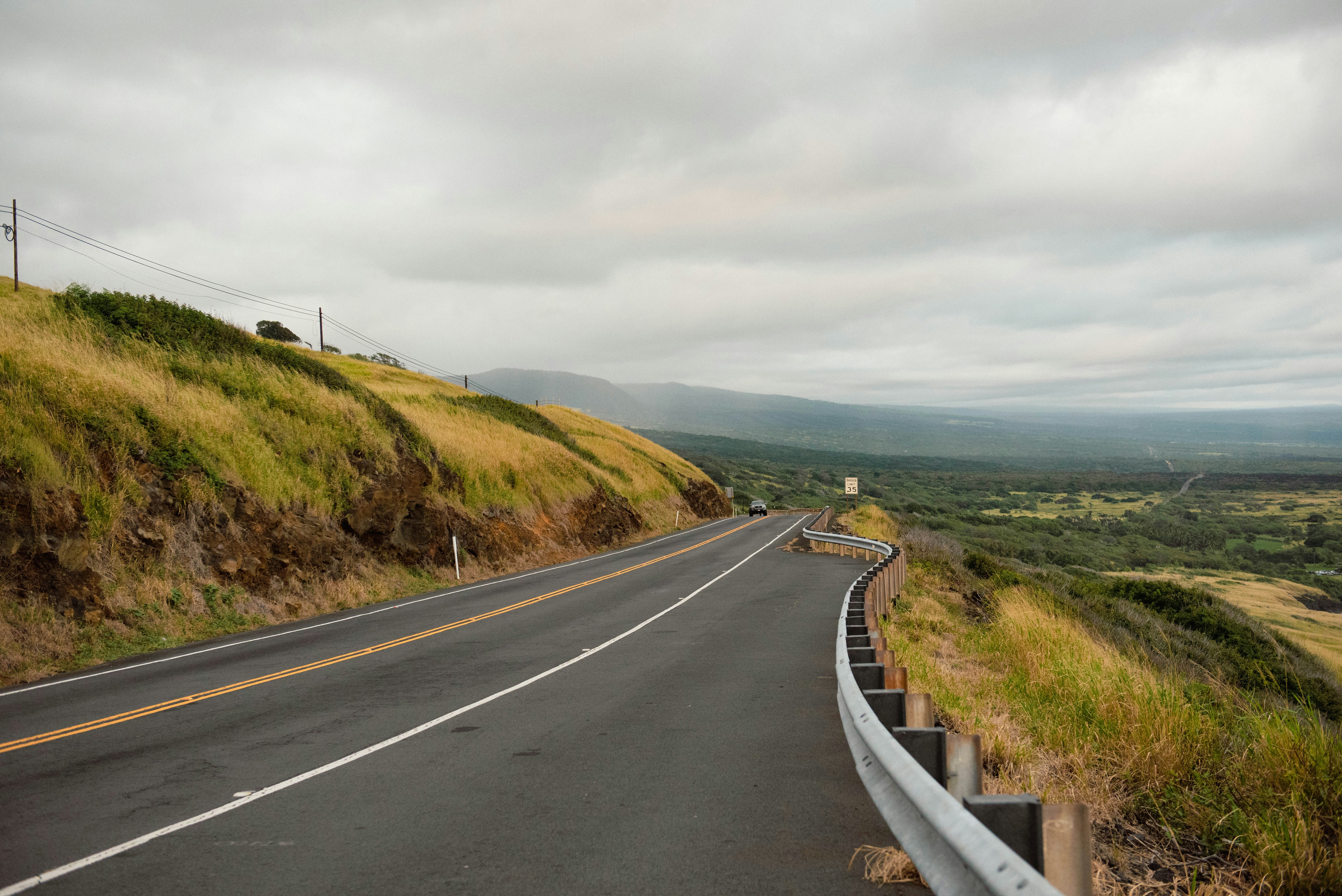 A winding road leads to a lush landscape.