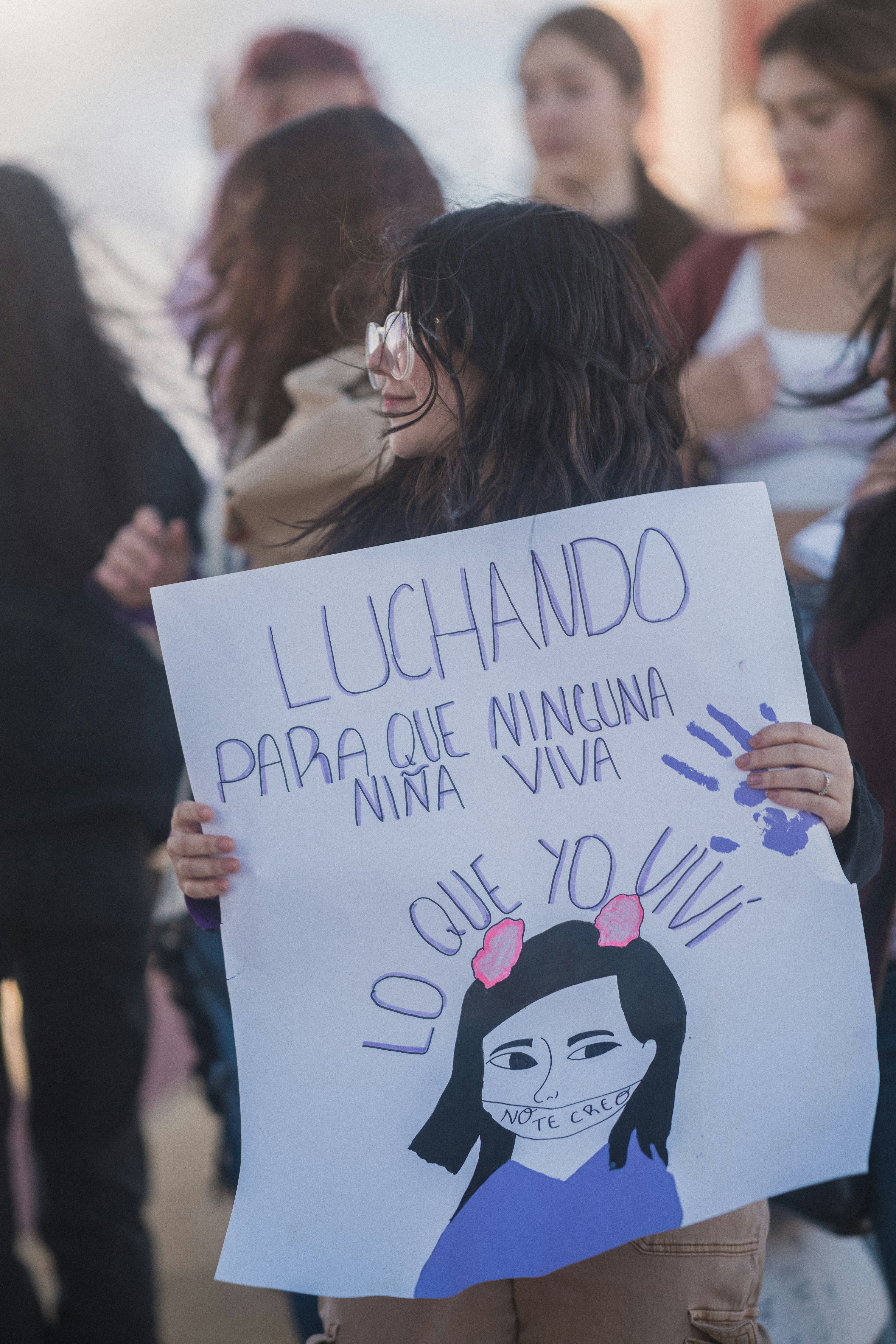 Protestor holds sign advocating for child's rights. photo – Free ...