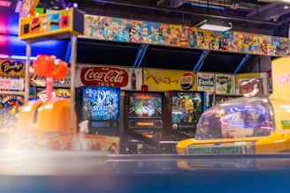 An arcade with pinball machines and colorful decorations.