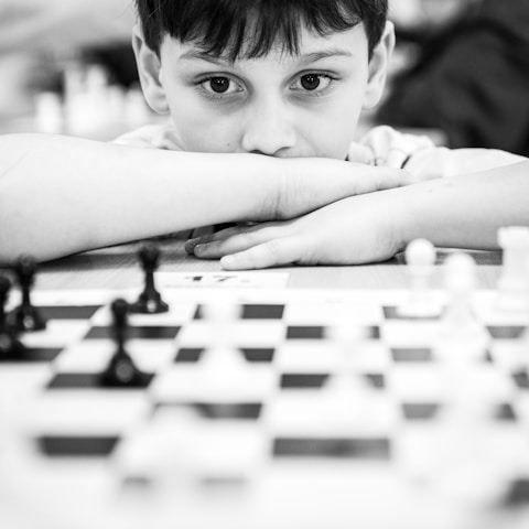 A boy concentrates while playing a chess game.