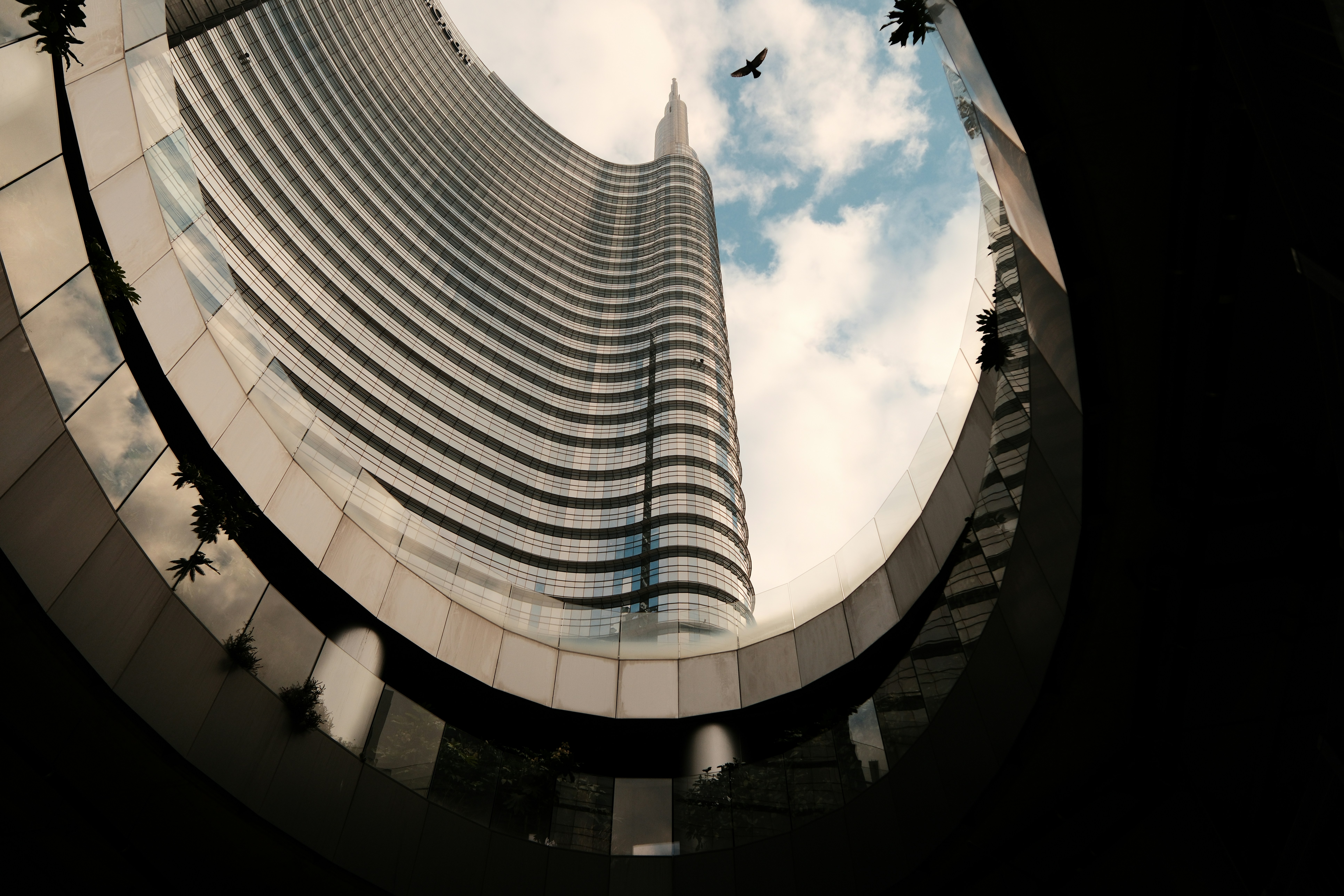 Skyscraper and sky seen from below.