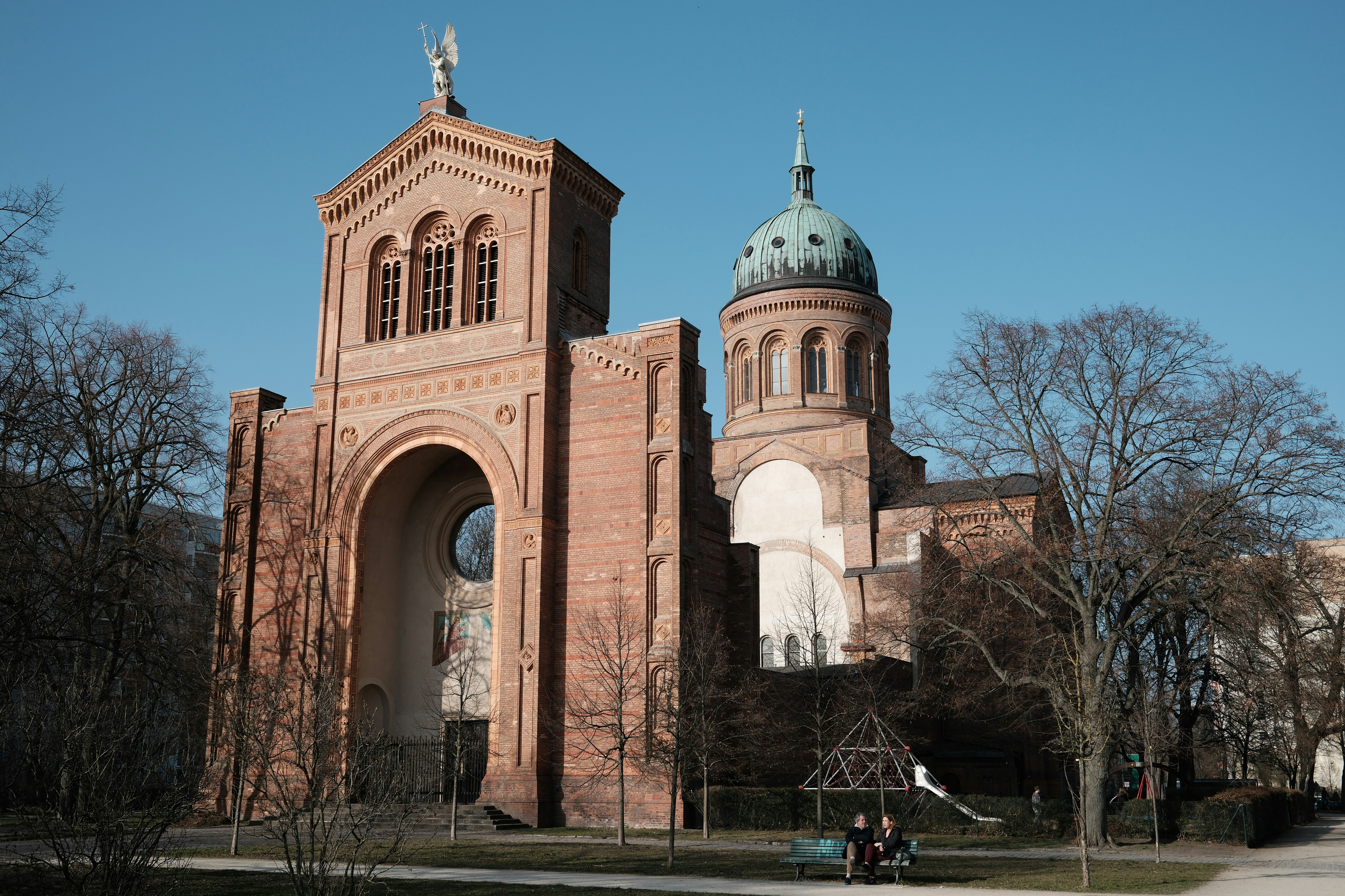 An architectural brick building with a blue sky.