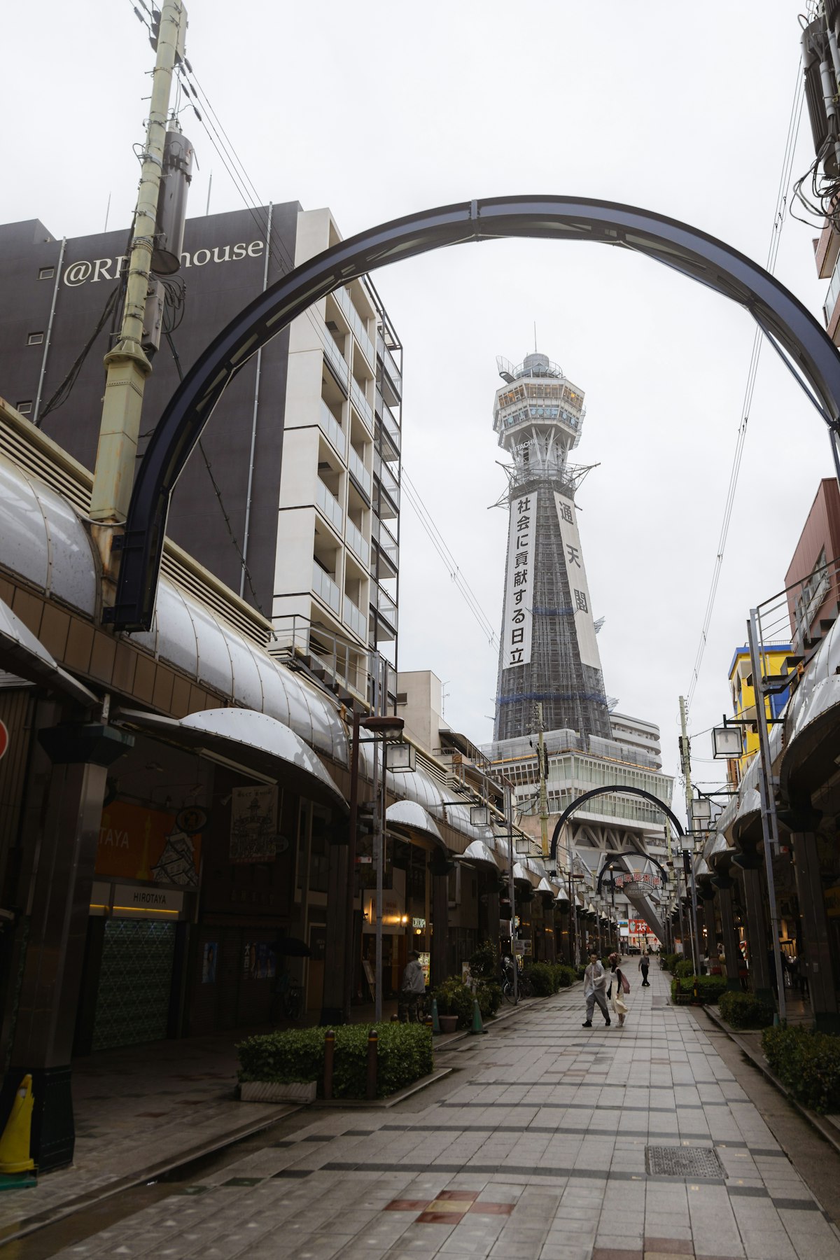 Tsutenkaku Tower viewed through a covered shopping arcade in Shinsekai, Osaka