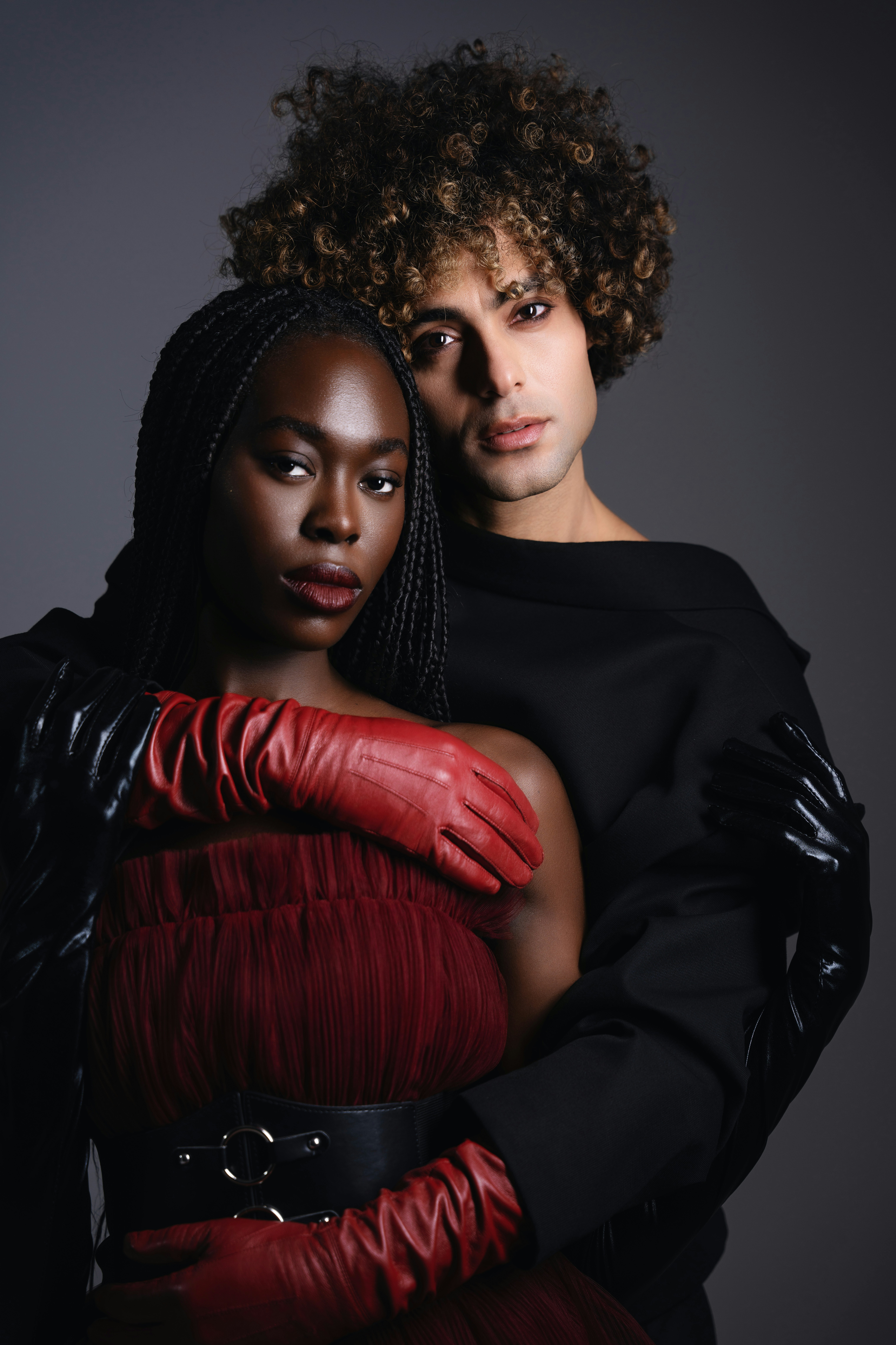 Fashionable couple poses in a studio.