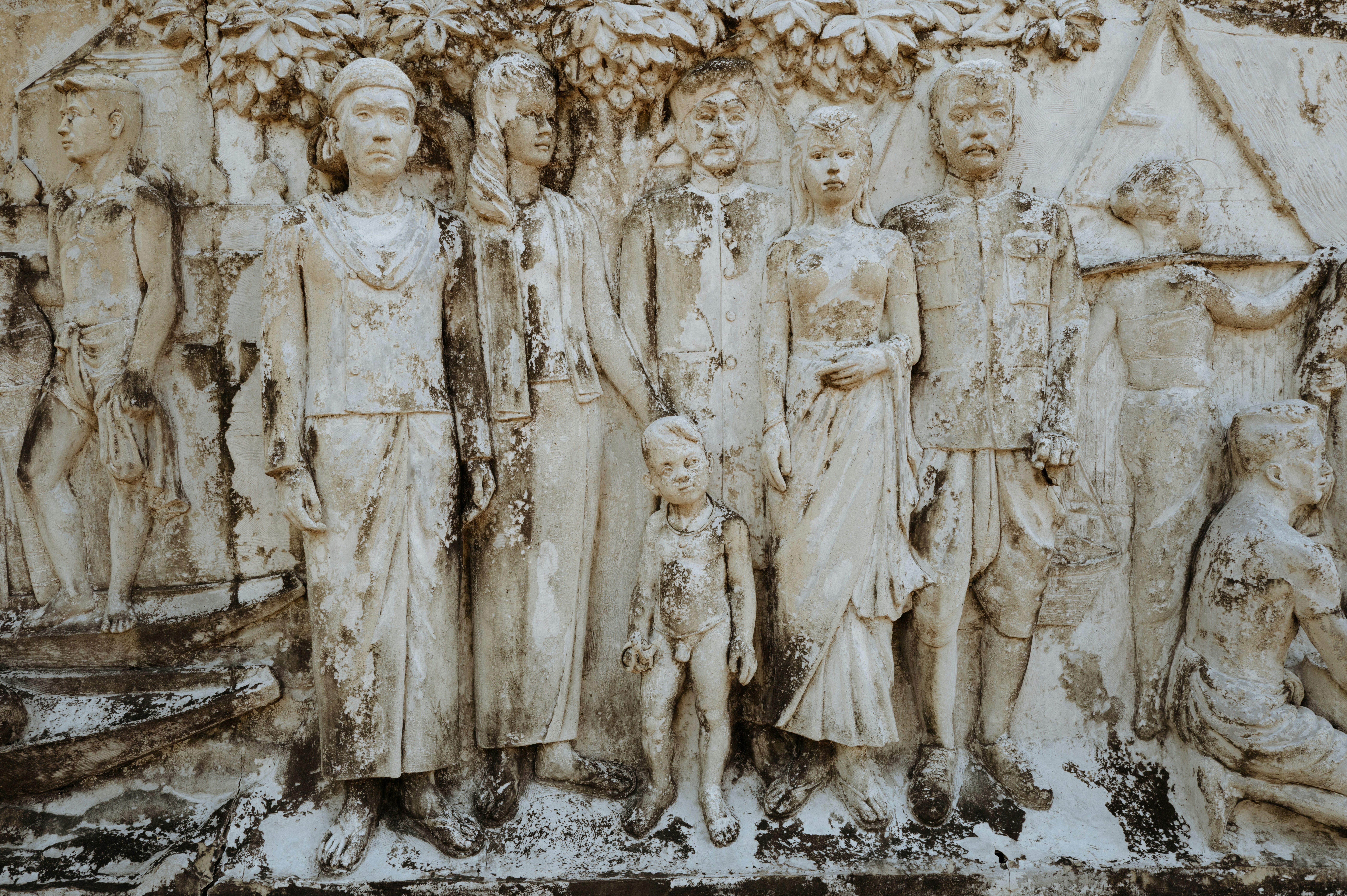 Relief sculpture of people standing together.