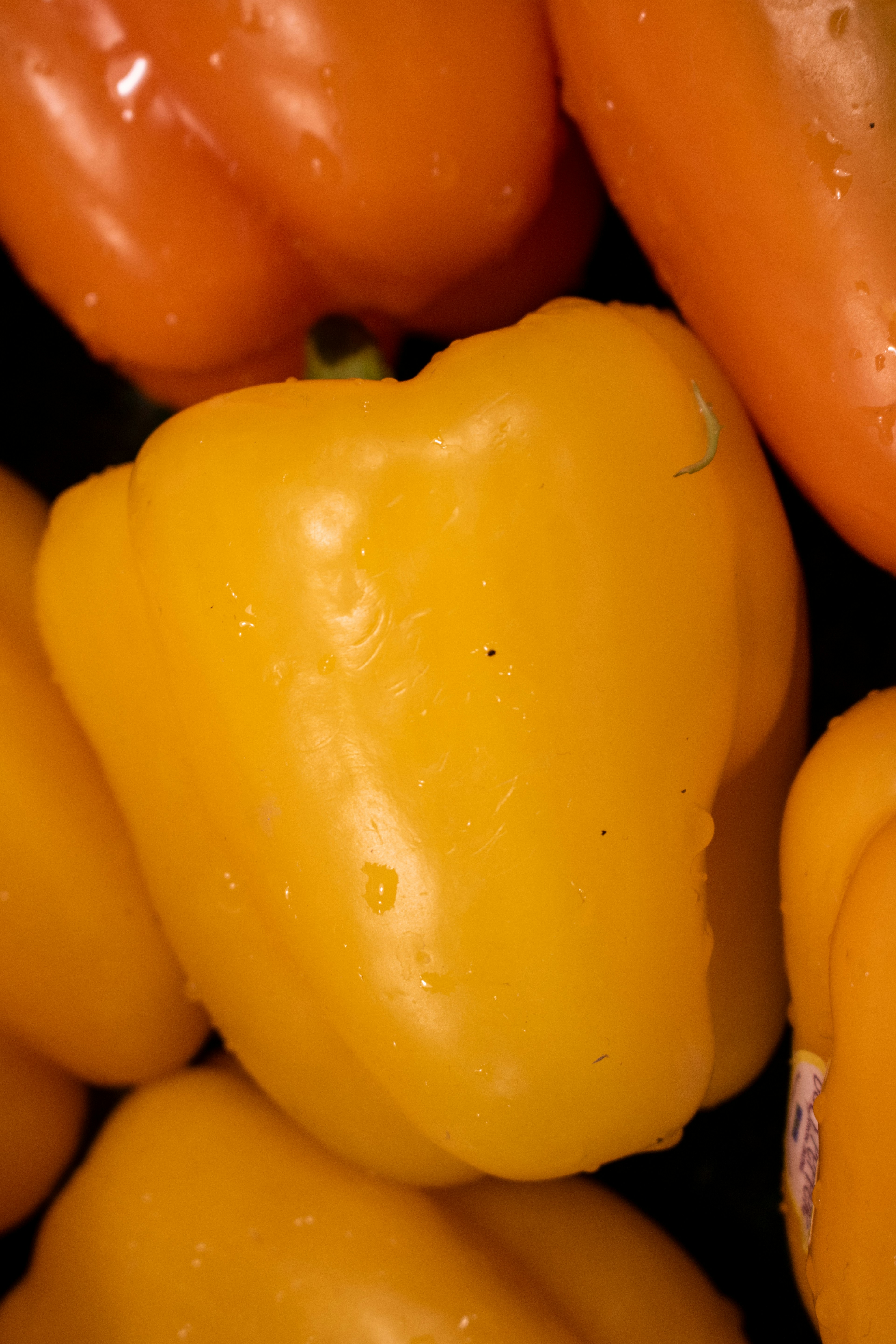 Yellow and orange bell peppers, close-up.