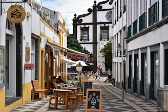 Street lined with buildings and outdoor cafes.