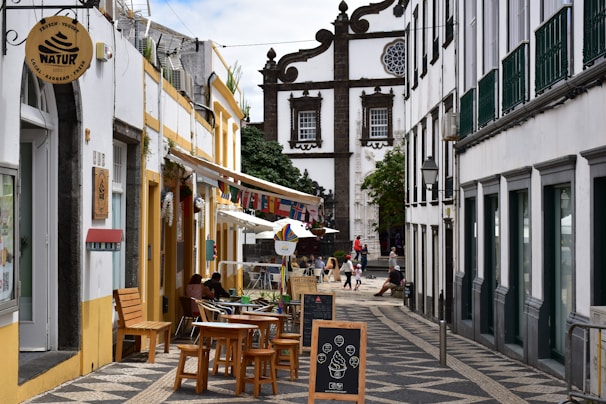 Street lined with buildings and outdoor cafes.