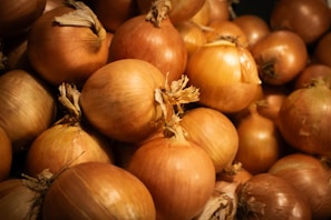 A pile of fresh, brown onions.