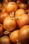 A pile of fresh, brown onions.