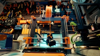 A 3D printer is in action in a workshop.