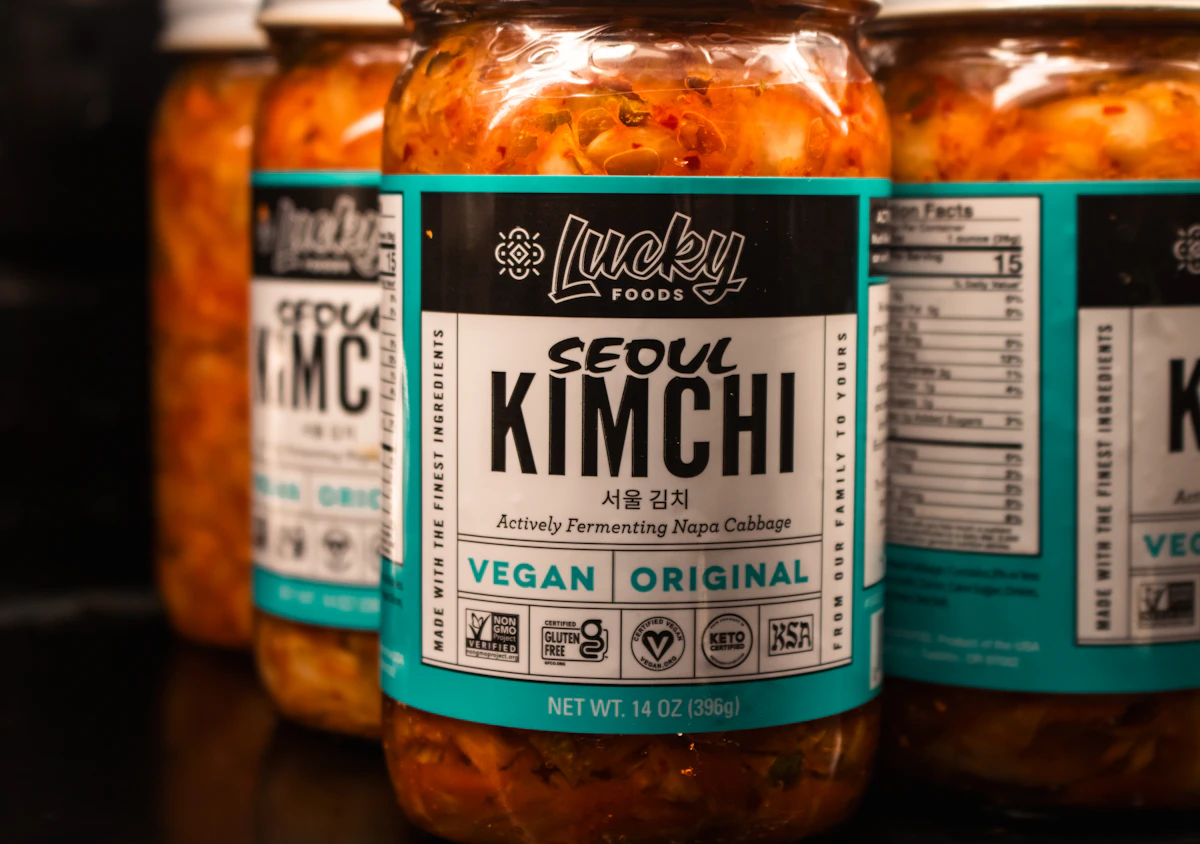 Kimchi jars are displayed on a black surface