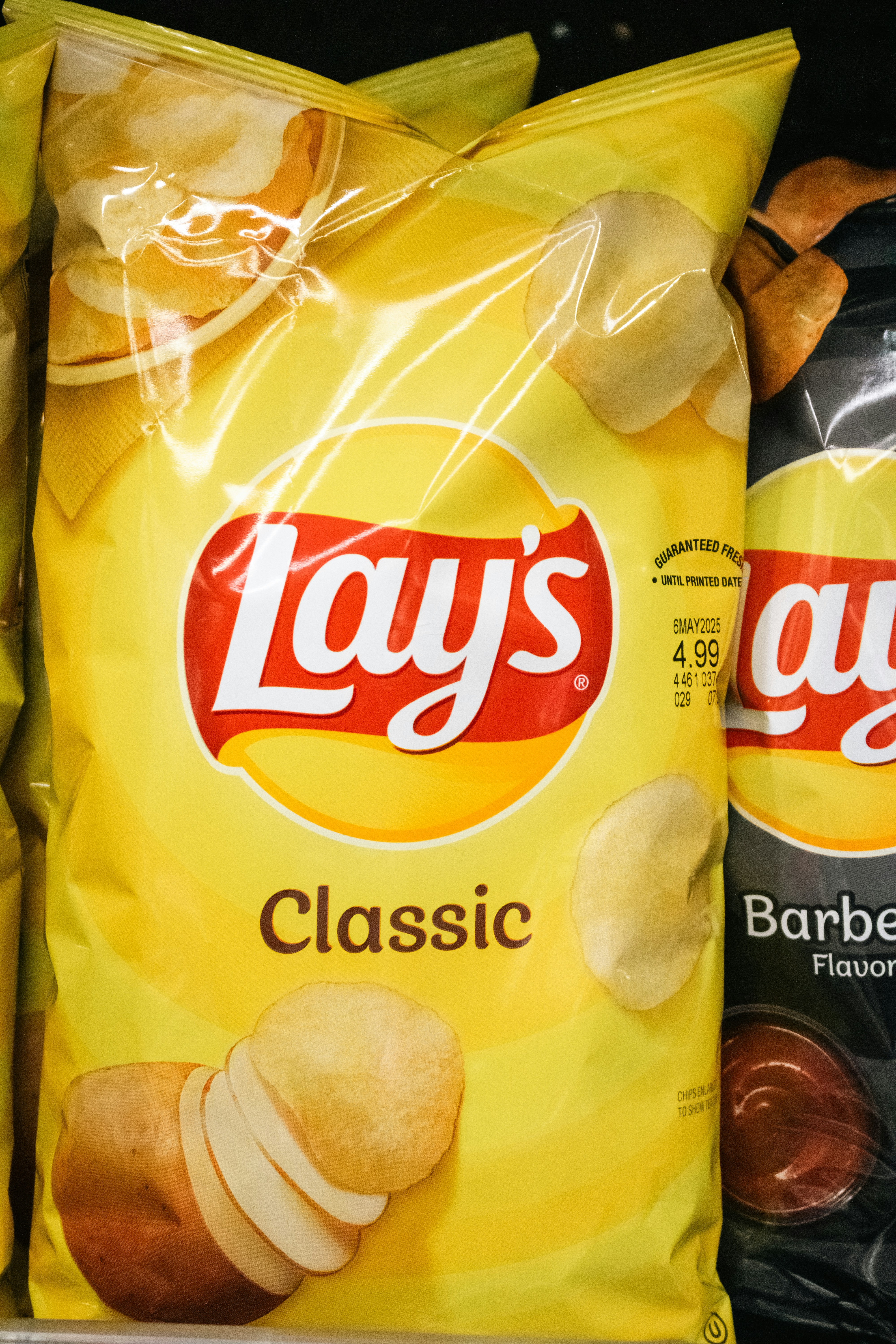 A bag of lays classic potato chips.