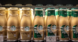 Starbucks frappuccinos chilled on a store shelf.