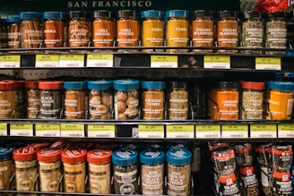 Shelves of various spice jars are displayed.