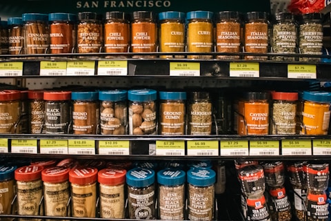 Shelves of various spice jars are displayed.