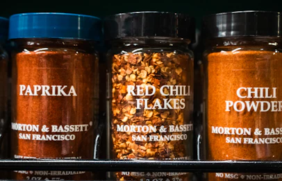 Spices: paprika, red chili flakes, and chili powder.