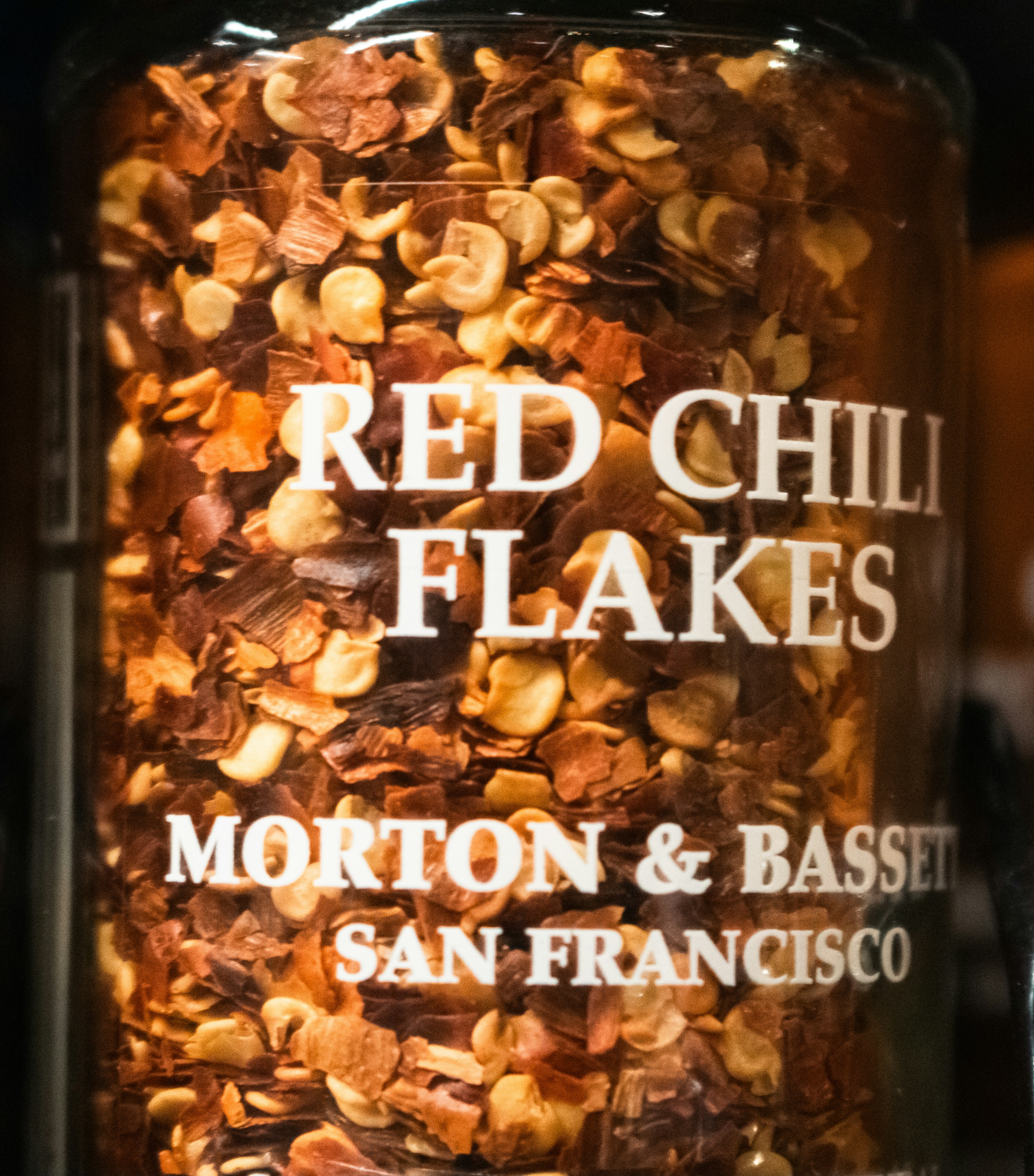 Jar of red chili flakes, ready to spice things up.