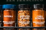Spices: paprika, red chili flakes, and chili powder.