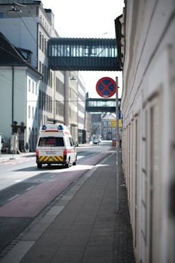 An ambulance travels down a city street.