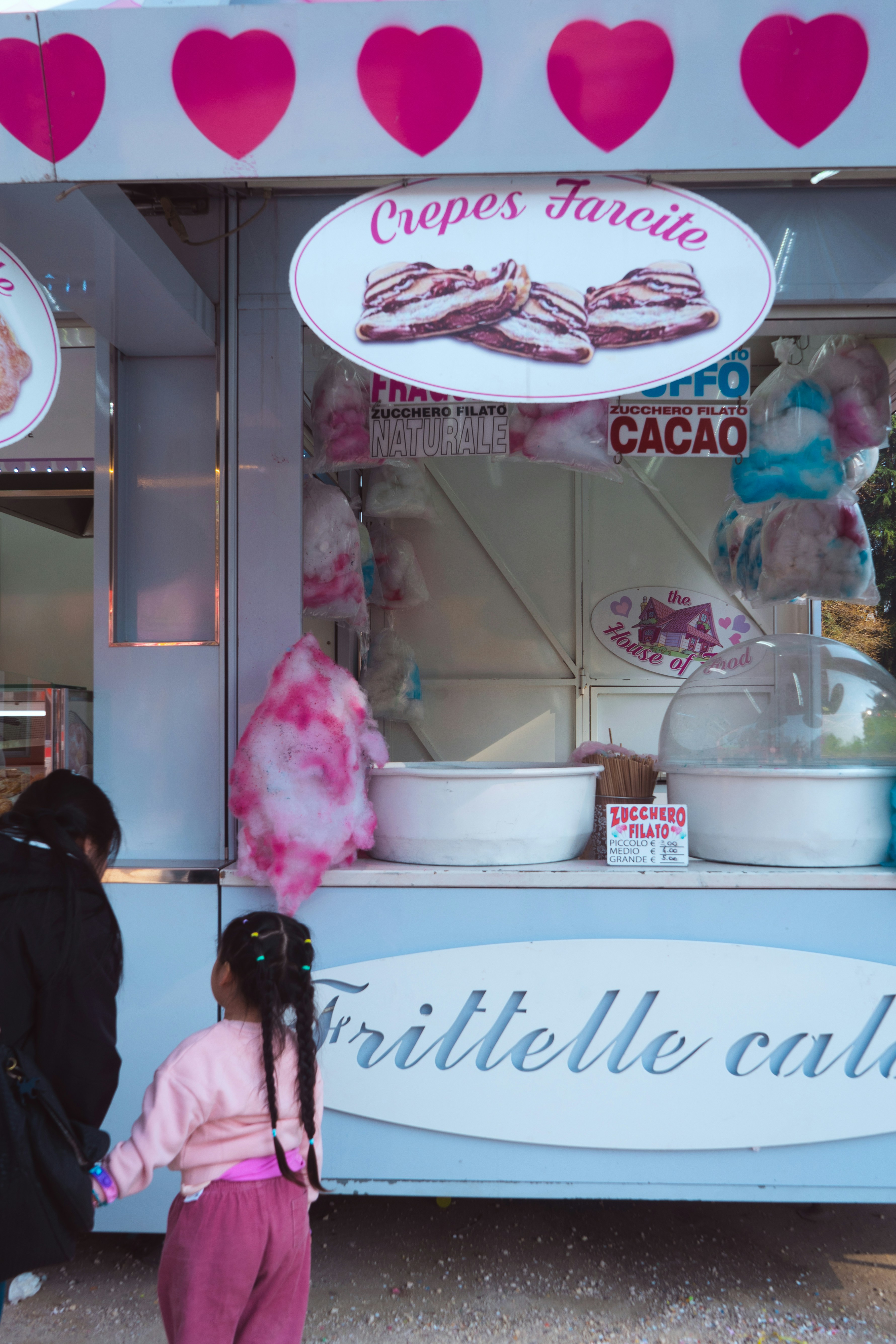 A girl and her mother buy sweet treats.