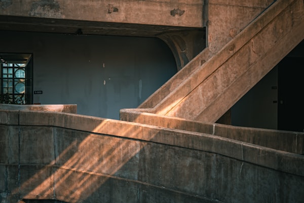 Concrete staircase with warm light and shadow — intentional architecture