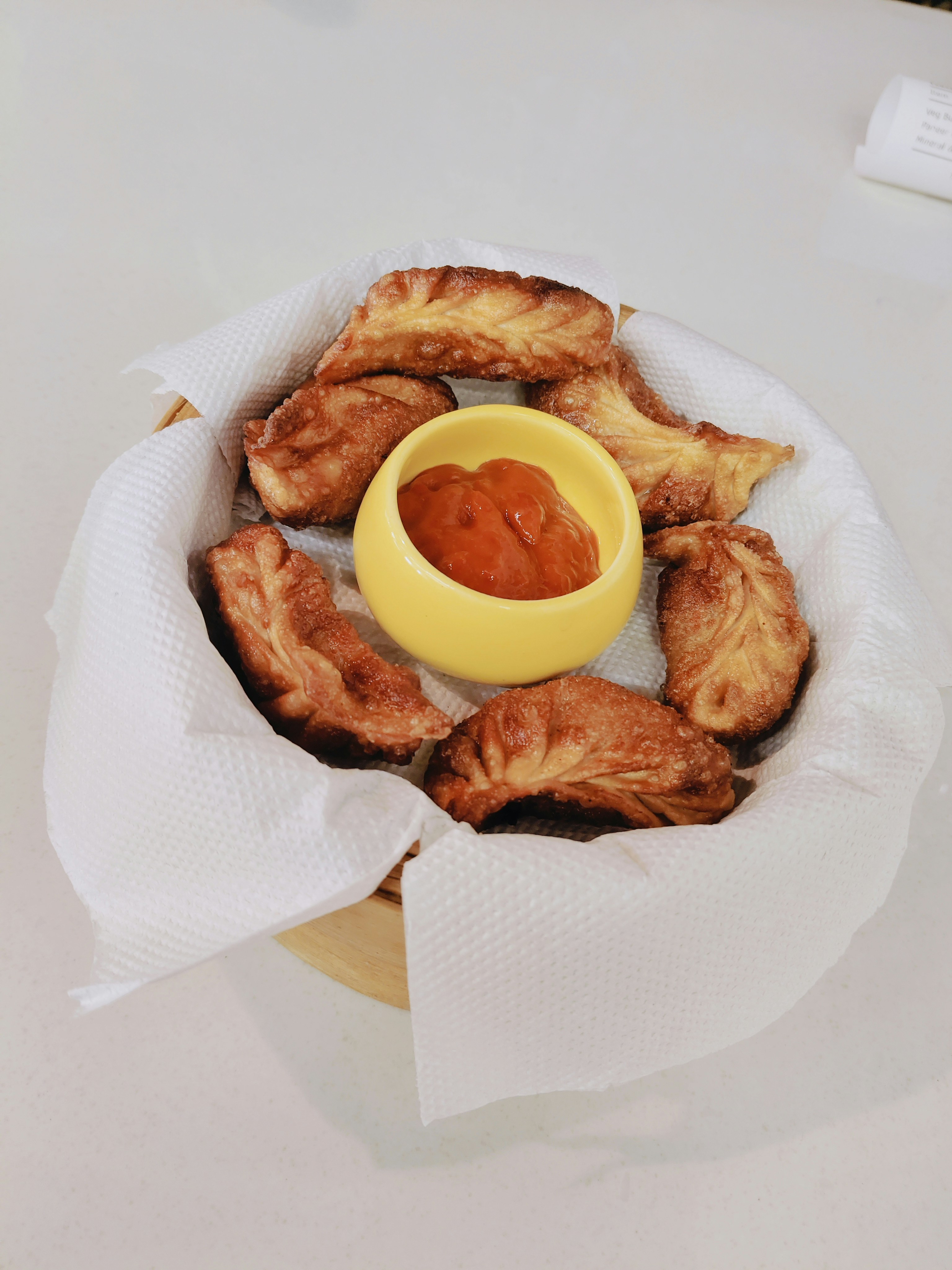 Fried pastries with a small sauce.