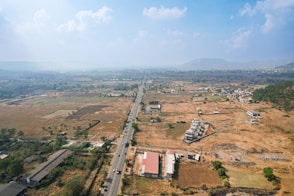 Aerial view of a town with a long road.