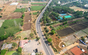 An aerial view of a road through fields.