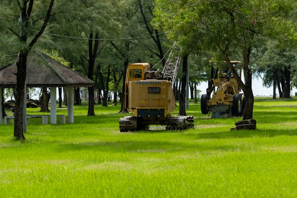 Construction equipment sits in a park.