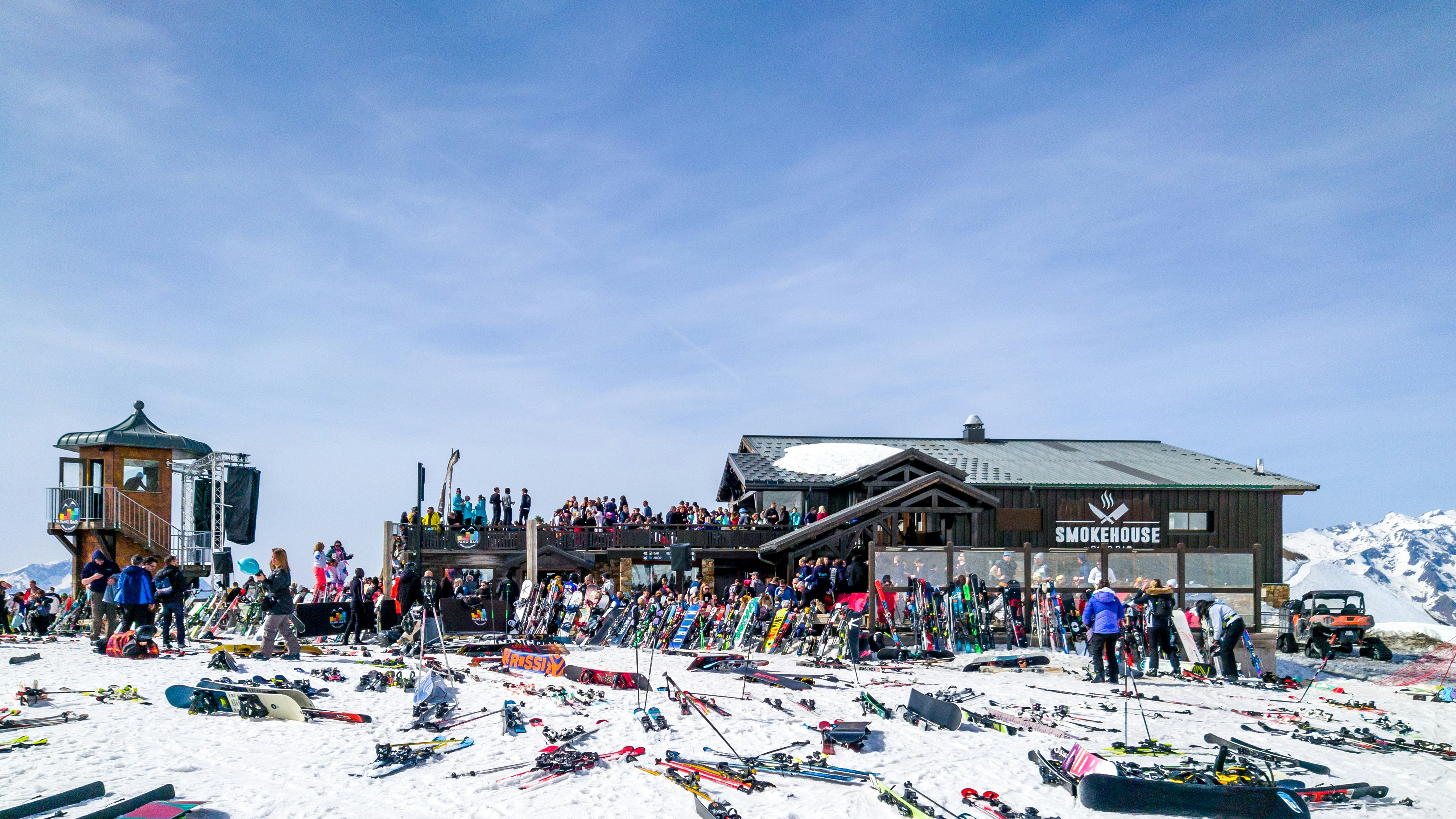 Ski resort with people and equipment in the snow.