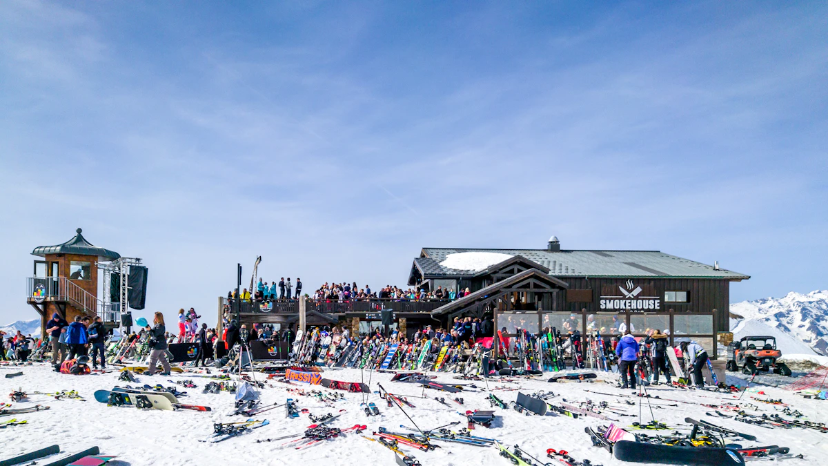 A packed mountain apres-ski bar with skis piled outside
