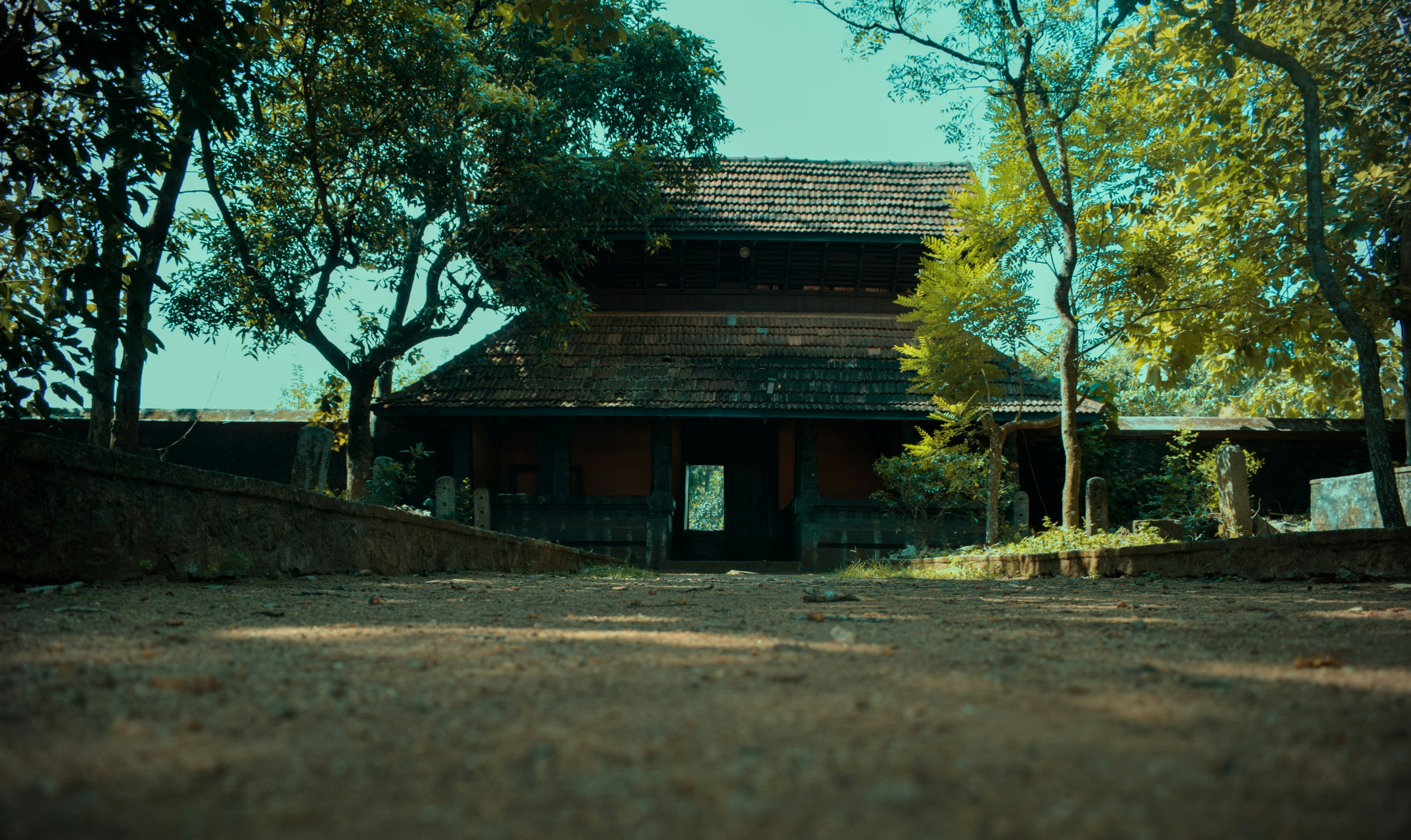 Traditional home nestled among lush greenery.
