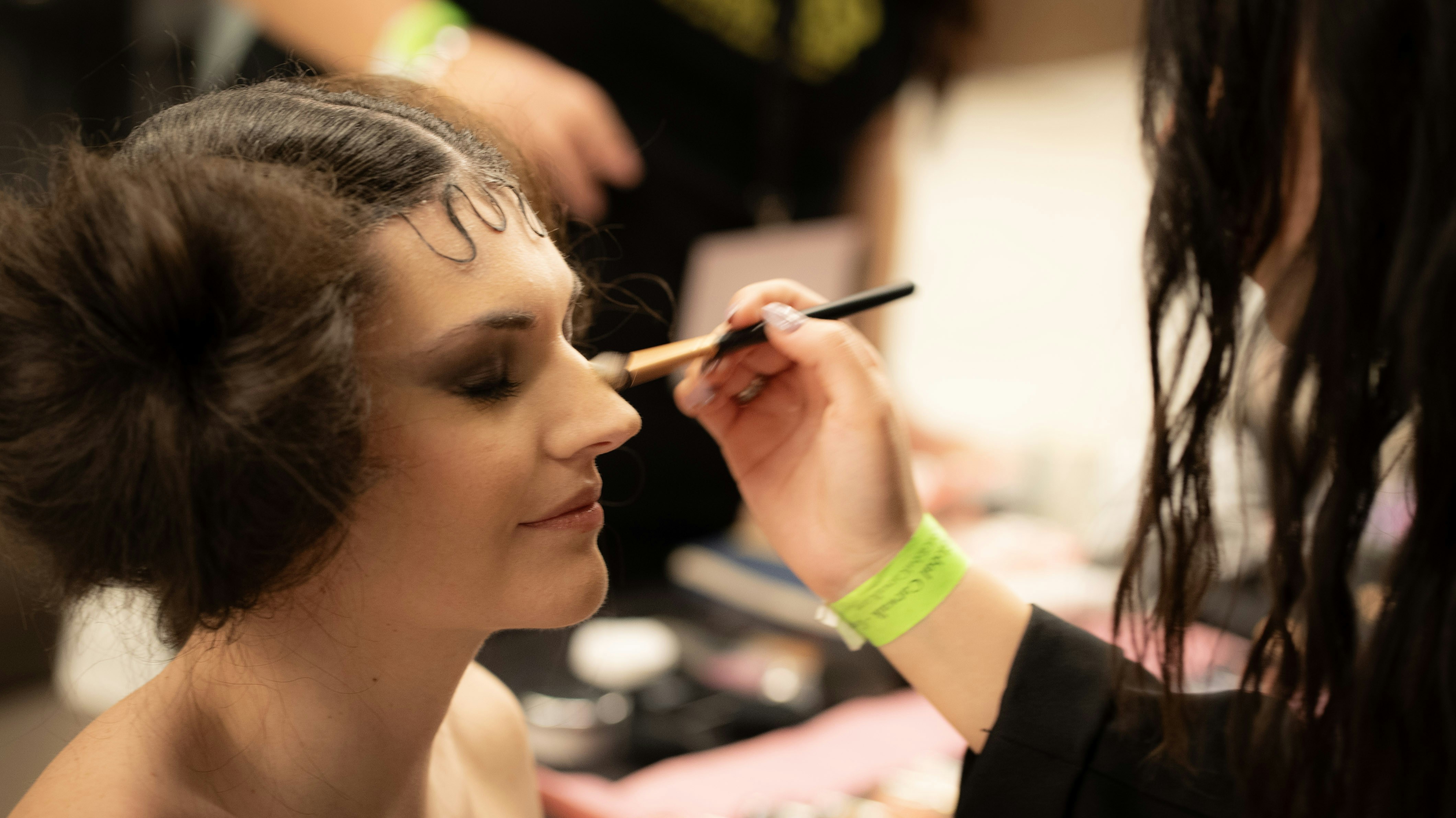 Makeup artist applying makeup on a model