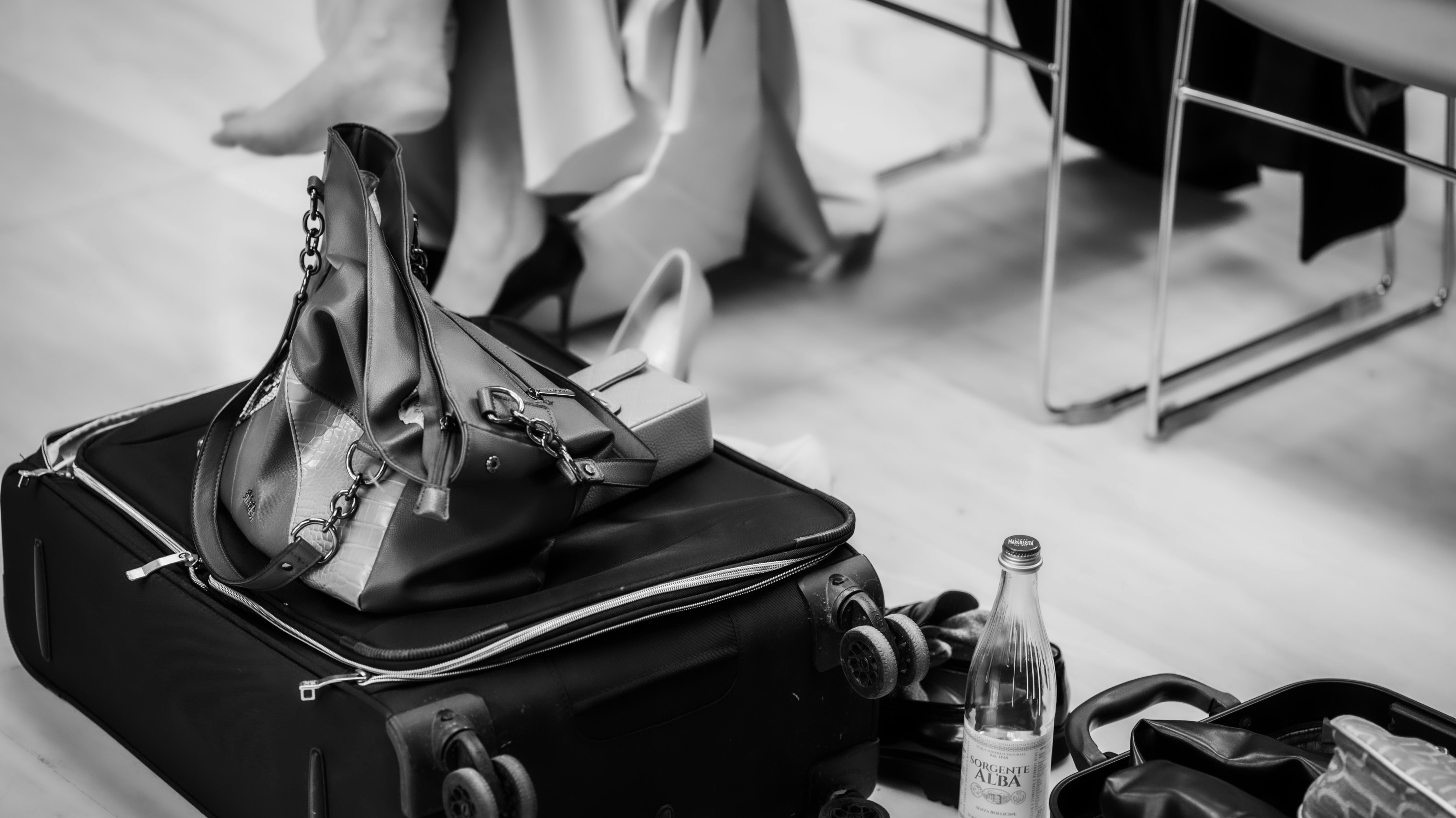 Luggage and accessories are packed for traveling.