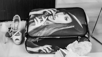 A suitcase, shoes, and a stylish woman.