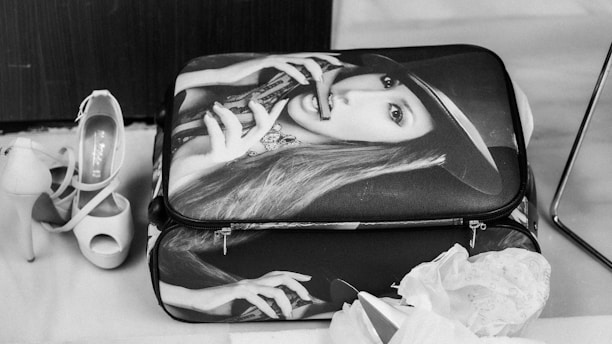 A suitcase, shoes, and a stylish woman.