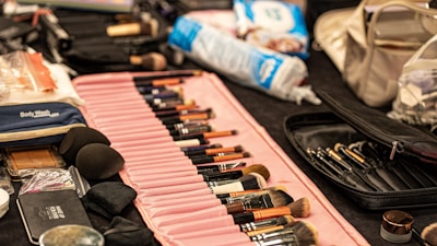 Makeup brushes and supplies are displayed on a table.