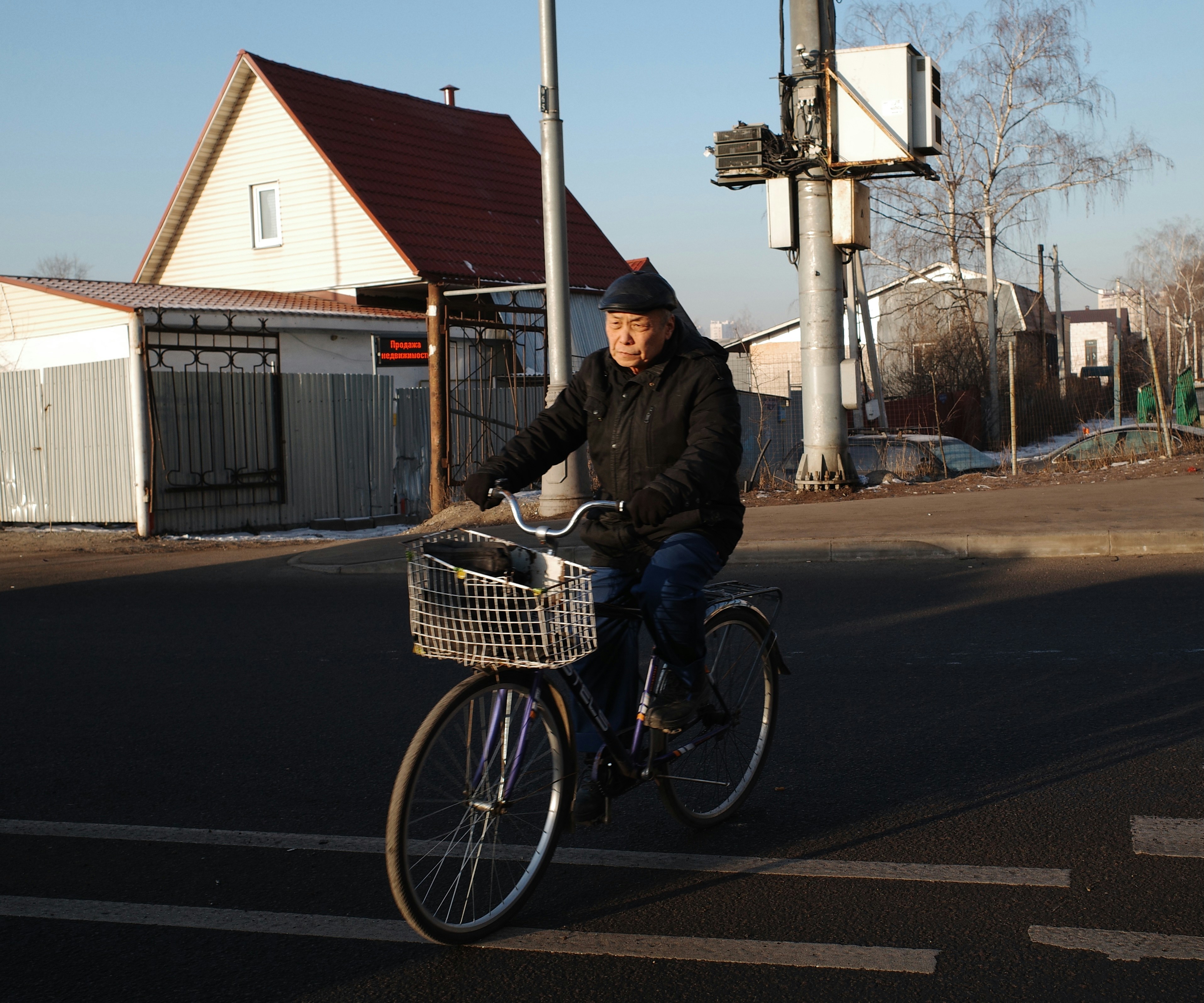 Old man on a bike. Street photo