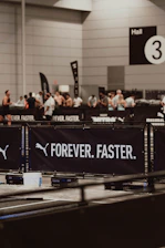 Puma's "forever. faster." banner at an event.