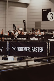 Puma's "forever. faster." banner at an event.