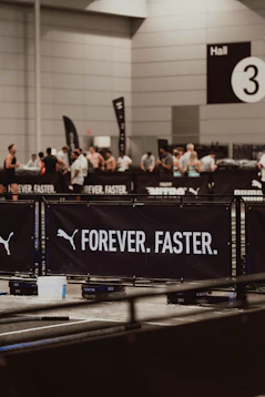 Puma's "forever. faster." banner at an event.
