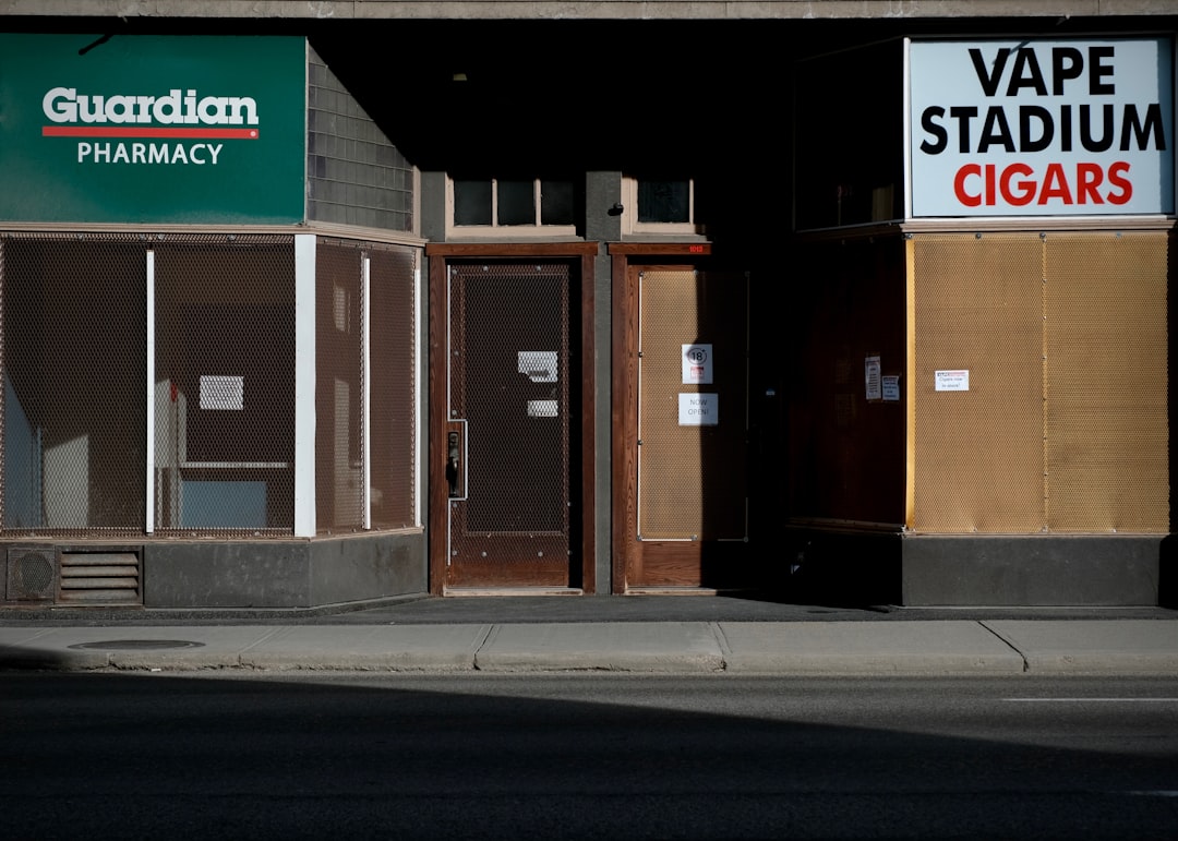 Closed pharmacy and vape shop sit side-by-side.,
